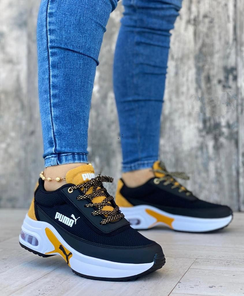 Tenis puma negro con amarillo sale